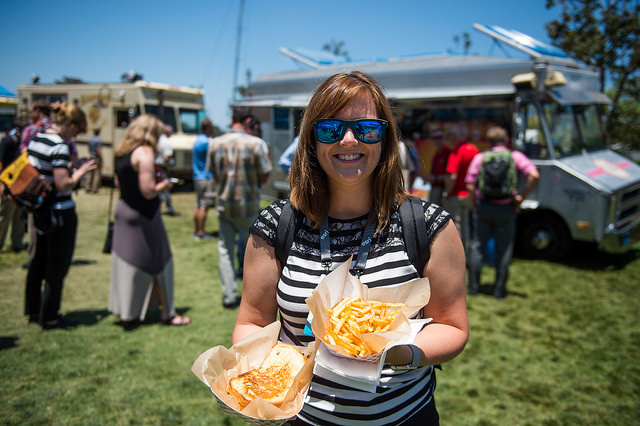 Woman holding food from a food truck