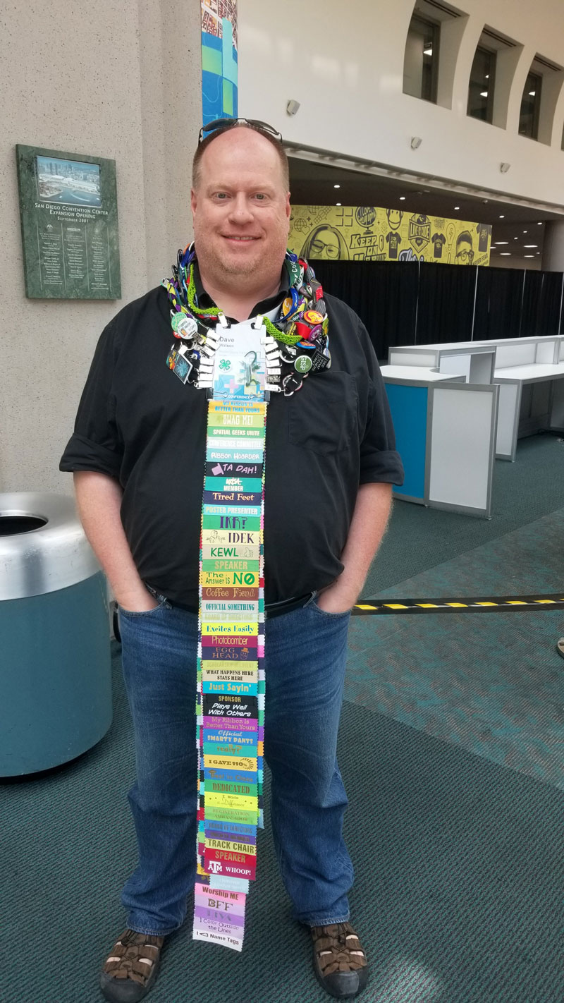 Dave displays his bundles of buttons and badges. 