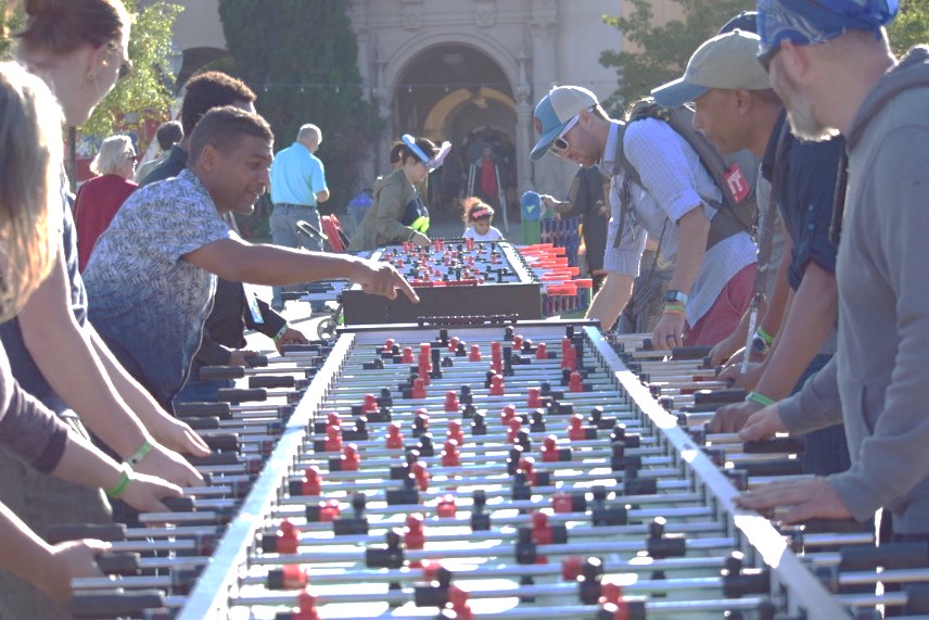 Group Plays on Foosball Game Table