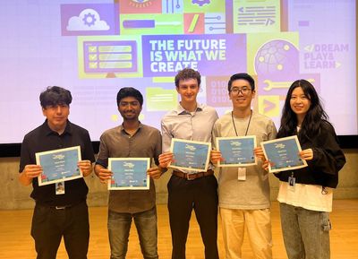 Third place winning team holding their certificates.