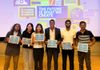 Second place winning team holding their certificates.