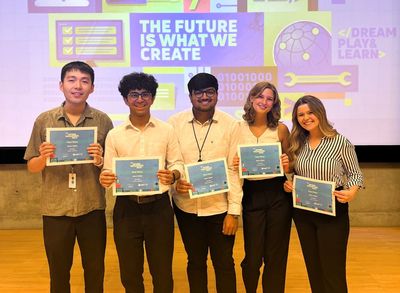 First place winning team holding their certificates.