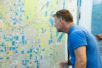 A person looking carefully at a map.  Our audience may be small, even a single person.