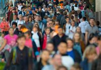 A crowd of people on a busy sidewalk. Our audience may be a large group.