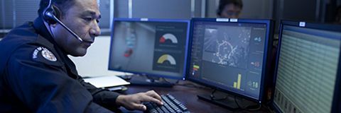 Police officer looking at ArcGIS Dashboards